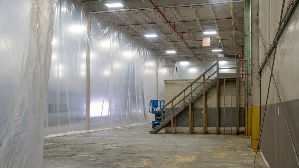 Des ouvriers installant des panneaux d'évitement en plastique sur une maison de deux étages